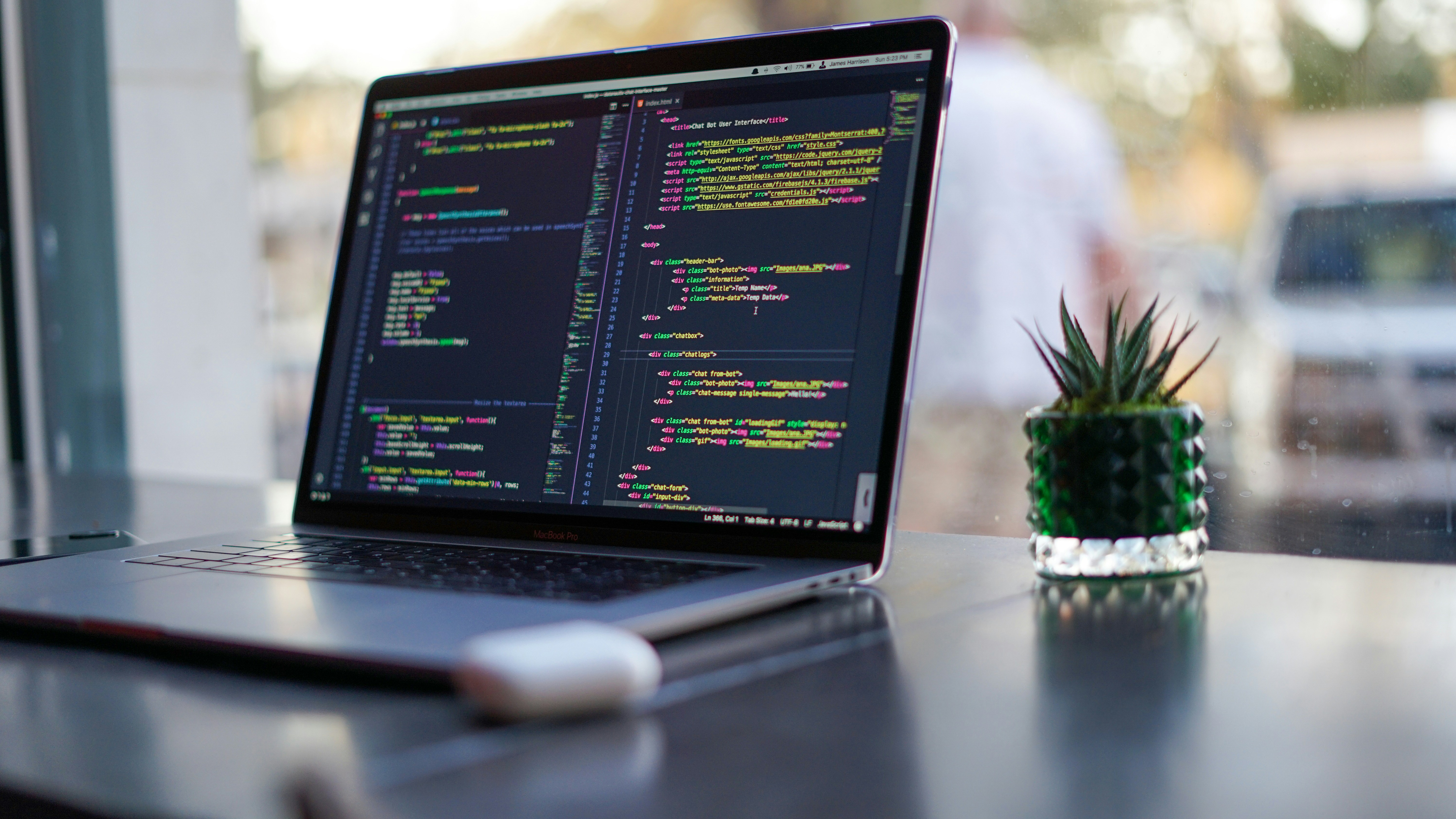laptop with code editor on the screen